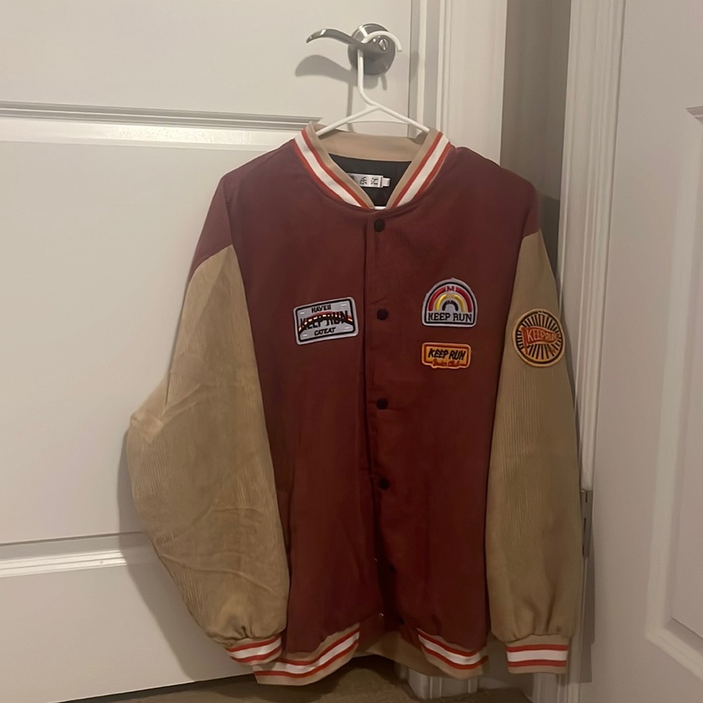 red and tan bomber jacket with patches